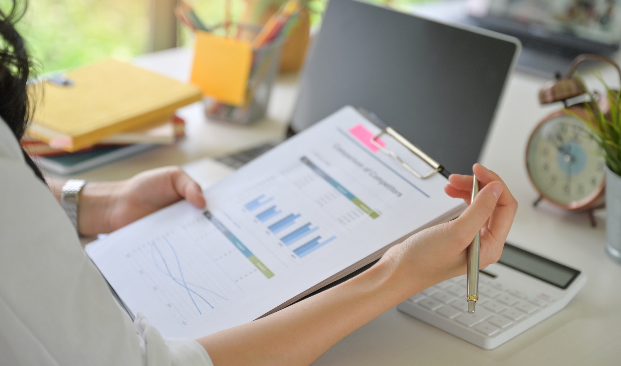 Close - up shot of Executives are checking the company's revenue graphs.